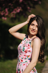 Naklejka premium Elegant woman in beautiful dress stand outside. Gorgeous model with make up and hairstyle