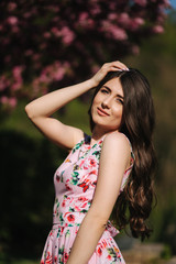 Naklejka premium Elegant woman in beautiful dress stand outside. Gorgeous model with make up and hairstyle