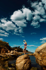 Beautiful athletic girl in a swimsuit on the background of the sea