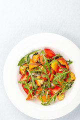 Salad with anchovies and sweet pepper, with croutons and arugula. On white background