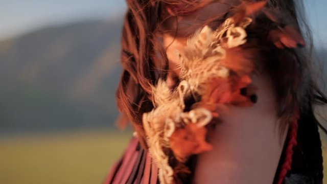 Native American girl face fragments on the blurred valley background