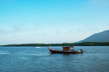 Fisherman Boat in the Morning Light in the Sea