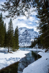 Landscape of Beautiful mountain lake in Alps. Braies Lake in Dolomites mountains. The lake is surrounded by forest. Lago di Braies, Italy.