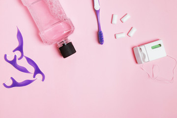 Dental care accessories on the pink background