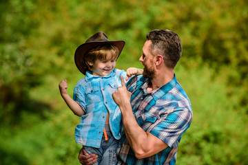 Spirit of adventures. Strong like father. Power being father. Child having fun cowboy dad. Rustic family. Growing cute cowboy. Small helper in garden. Little boy and father in nature background