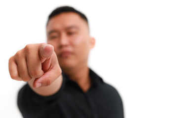 Young asian man pointing to the front with finger, isolated on white background.