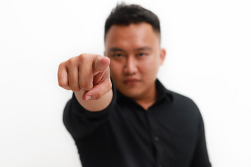 Fototapeta premium Young asian man pointing to the front with finger, isolated on white background.