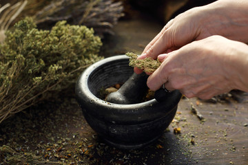 Herbal mixture. The woman prepares natural herbal medicines.