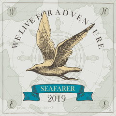 Fototapeta na wymiar Vector banner with hand-drawn seagull on the background of old map and steering wheel in retro style. Illustration on the theme of travel, adventure and discovery with words We live for adventure