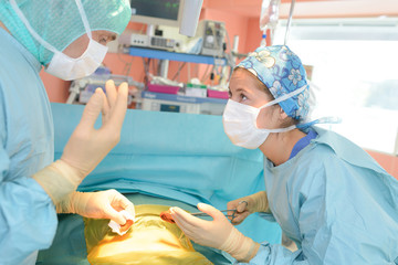 surgeon and nurse discussing while operation