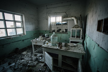 Dark creepy abandoned chemical laboratory, broken glassware