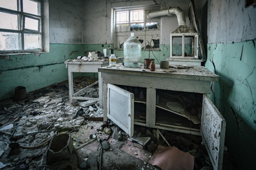 Dark creepy abandoned chemical laboratory, broken glassware