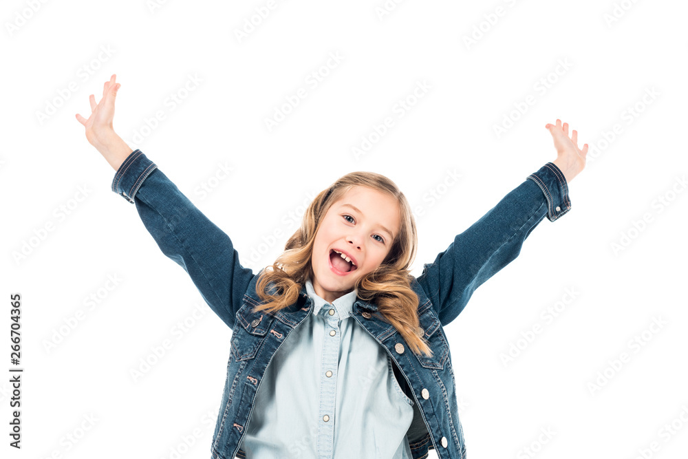 Wall mural excited curly kid in denim jacket waving hands and laughing isolated on white