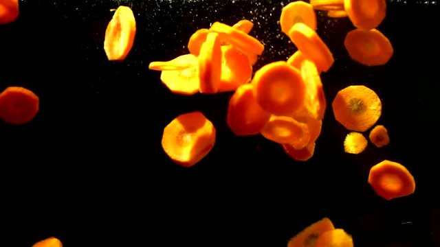 carrots spilling ito the water slow motion 100 fps