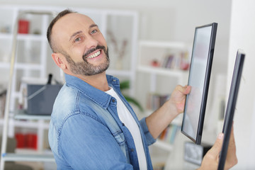man hanging a blank poster in exhibition hall