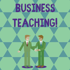 Handwriting text Business Teaching. Conceptual photo teaching the skills and operation of the business industry Two Businessmen Standing, Smiling and Greeting each other by Handshaking