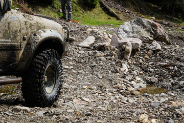 Fototapeta na wymiar Wheels in the marsh. Offroad on Jeep in the Carpathian Mountains