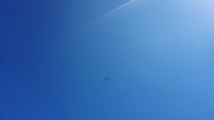 Airplane frying in the blue sky - sunny day