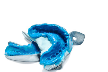 Two dental impressions on a white background with copy space. The imprint of the tooth row of high precision. © baklykovadaria