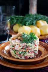 Served one-portion salad of beans, ham, crackers on a clay plate, selective focus