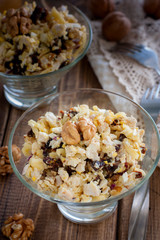 Salad of walnut, chicken and prunes in glass salad bowls, selective focus