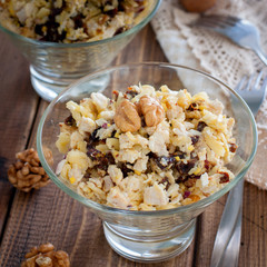 Salad of walnut, chicken and prunes in glass salad bowls, selective focus