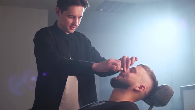 Hair removal. Man's face sugaring epilationsy ellow color, in cosmetology on the couch. hair removal inside the nose