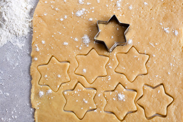 The process of making cookies and gingerbread at home. Rolled dough with carved asterisks. pattern view from above