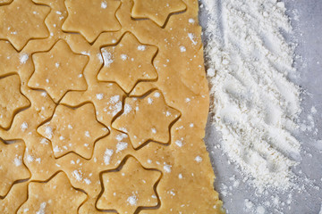 The process of making cookies and gingerbread at home. Rolled dough with carved asterisks. pattern 