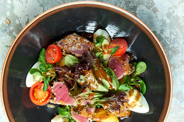 Warm Tuna Salad. Beautiful serving dishes. Light gray background. Restaurant menu