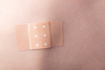 The wound is taped on the back of a person