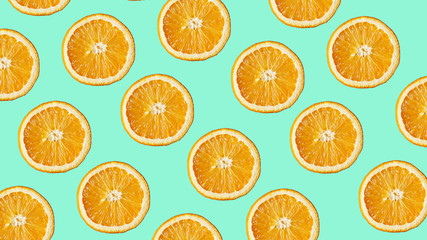 Colorful fruit pattern of fresh orange slices on modern blue background. From top view