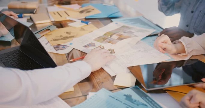 Teamwork and brainstorming. Close-up hands of business colleagues working together at corporate modern office meeting.