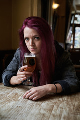Emo girl drinking alone in the pub