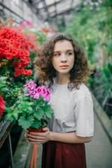 The young girl walks in a summer garden