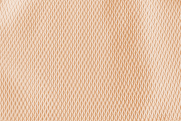 Texture of beige fabric with structure. Fabric for dresses, skirts, jackets, trousers, shorts, dresses. Patterned fabric
