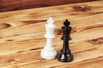 Chess figures on wooden background close up