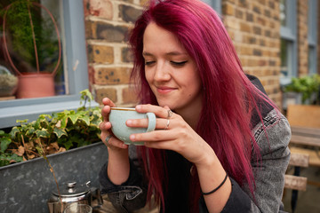 happy girl next door smiling and drinking tea