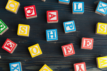 Alphabet blocks ABC on wooden table.