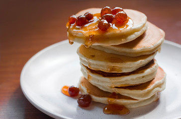 pancakes with strawberry jam. Strawberry jam. pancakes with syrup. pancakes on a plate