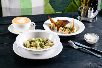 Two plates with the meal on the table, view from above