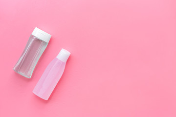 skin care cosmetics with facial tonic, mycelial water on pink background top view mockup