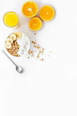 Bright breakfast with granola and orange juice on white background top view mockup