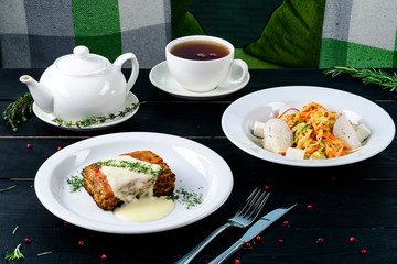 Two plates with the meal on the table, view from above