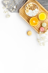 Bright breakfast with granola and orange juice on white background top view mockup