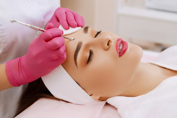Professional cleansing of acne in a beauty salon.