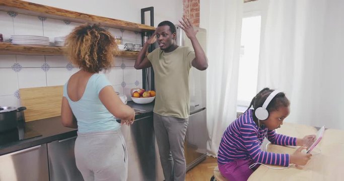 Parents arguing in front of their daughter