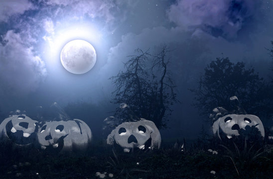 Moon, fog, autumn garden and Halloween pumpkins on the grass