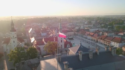 Aerial sunset view over the town of Pszczyna in Southern Poland with a polish flag flying on top of a building