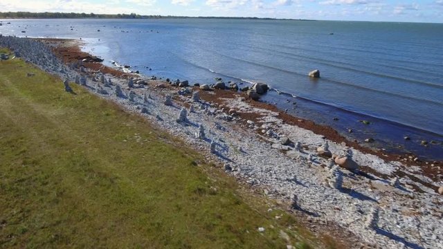 A Rock Pile of stones on the shore of the beach in Saarema Estonia with the small waves on the beach